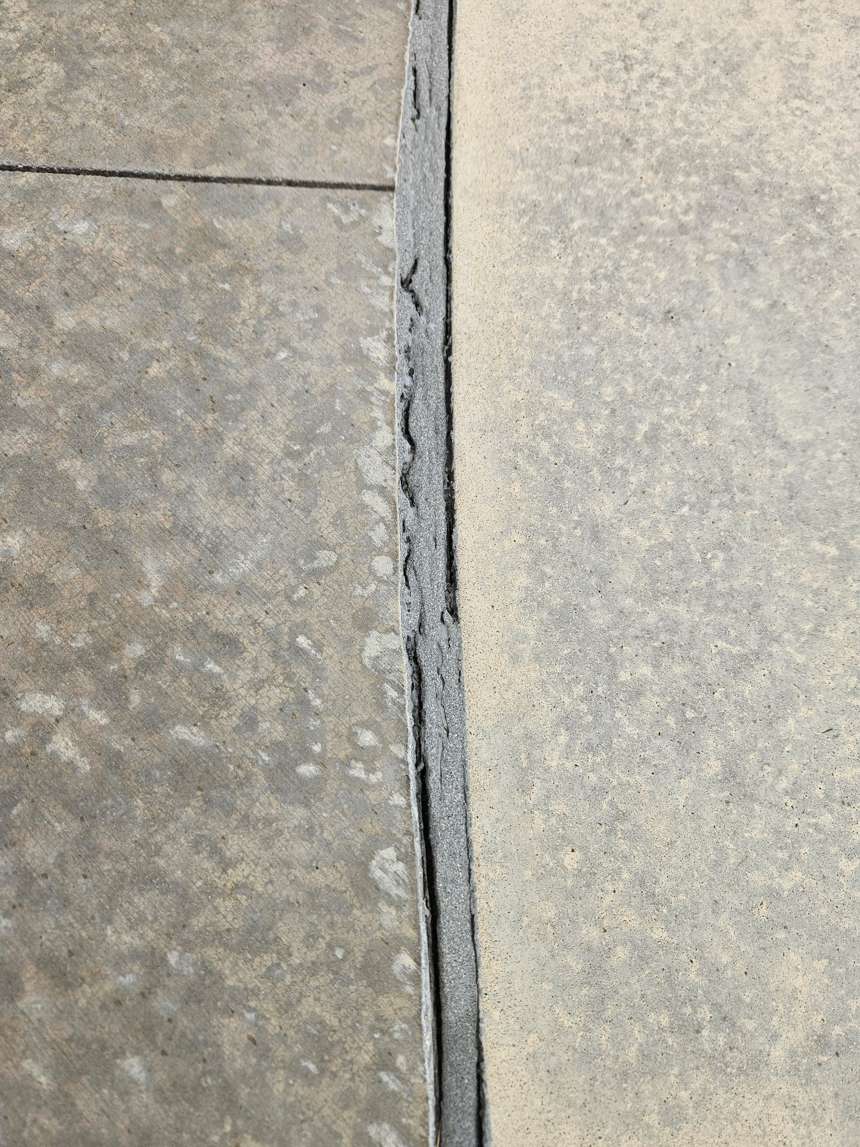 Cracked and separated pool mastic joint letting water under the deck