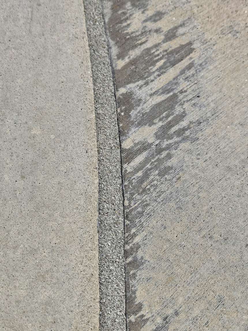 Clean new sand finish pool mastic joint after one day replacement