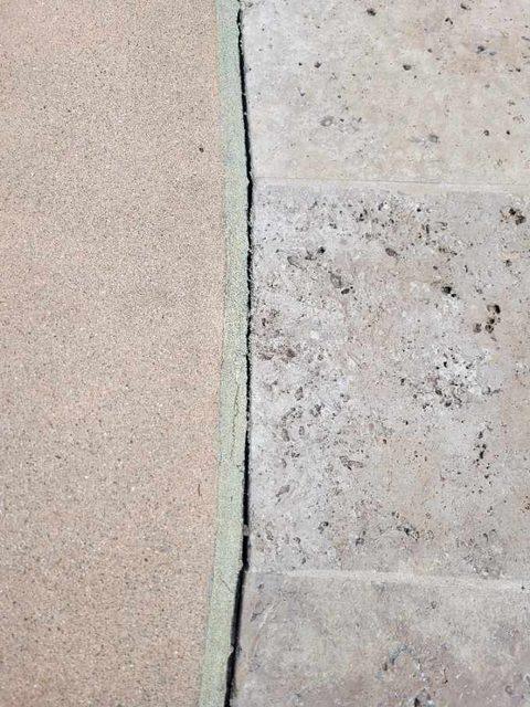 Joint finished where sand finish concrete meets travertine