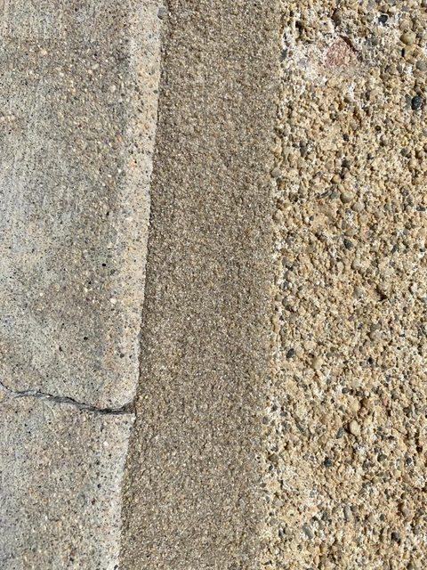 Tan bead against exposed aggregate decking
