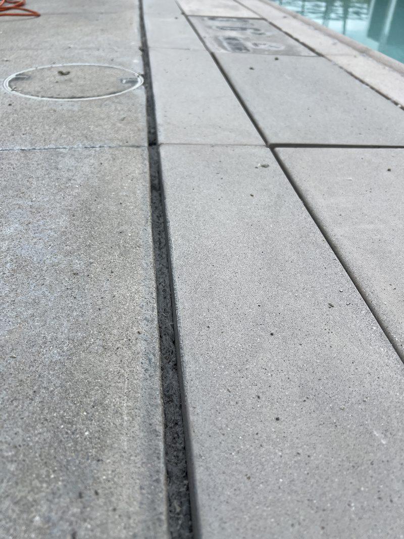 Backer rod set in a cleaned joint beside the coping