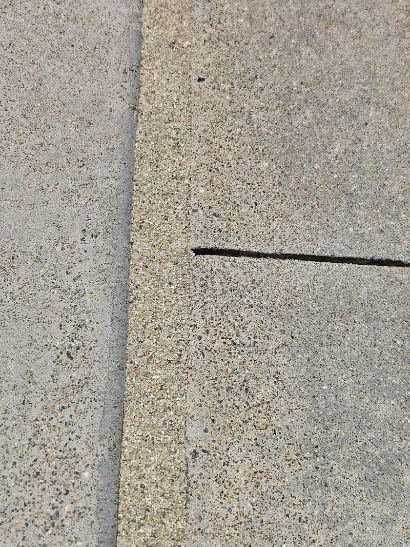 Tan sand finish reading as part of the deck, not a stripe