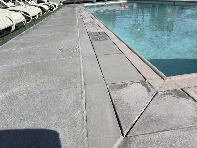 A community lap pool deck, the full run sealed end to end